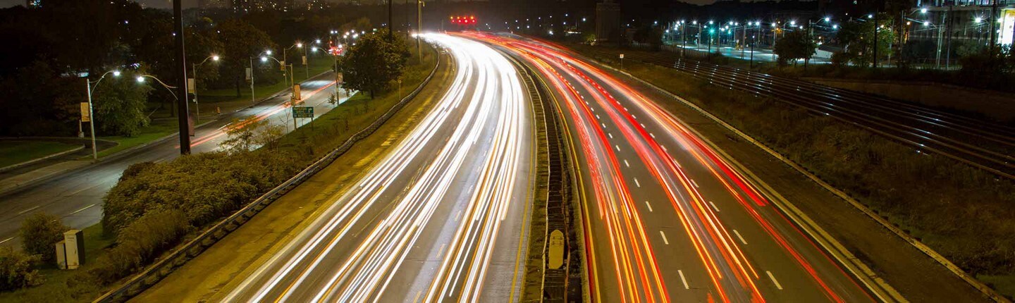 A highway and cars driving at night