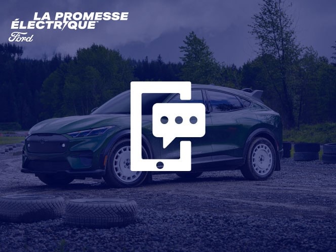 Une Ford Mustang Mach-E verte sur une route de terre avec des arbres en arrière-plan avec un téléphone cellulaire et une icône de texte superposés.