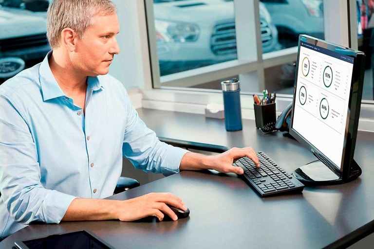 Un homme d’affaires assis à son ordinateur examinant des informations télématiques