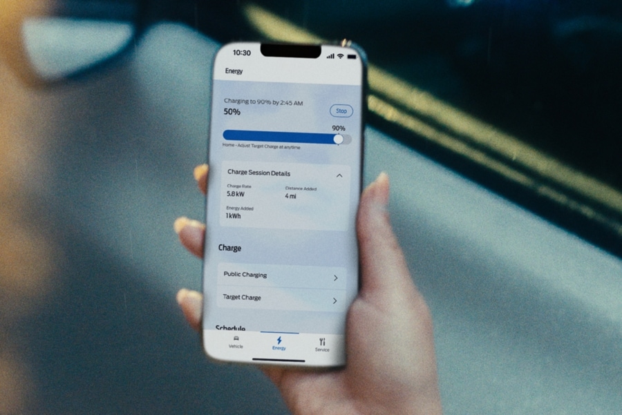 Une personne tenant un téléphone cellulaire avec l'application FordPass.
