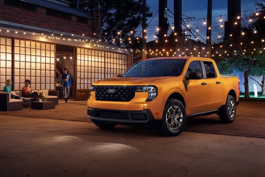 2026 Maverick® pickup parked near a building under lights at night