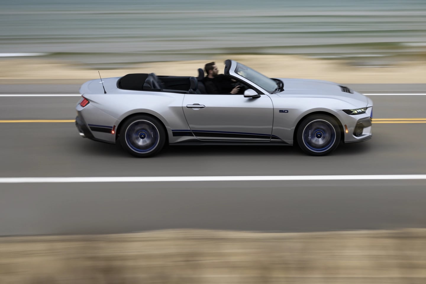 Une Mustang décapotable conduite sur une autoroute