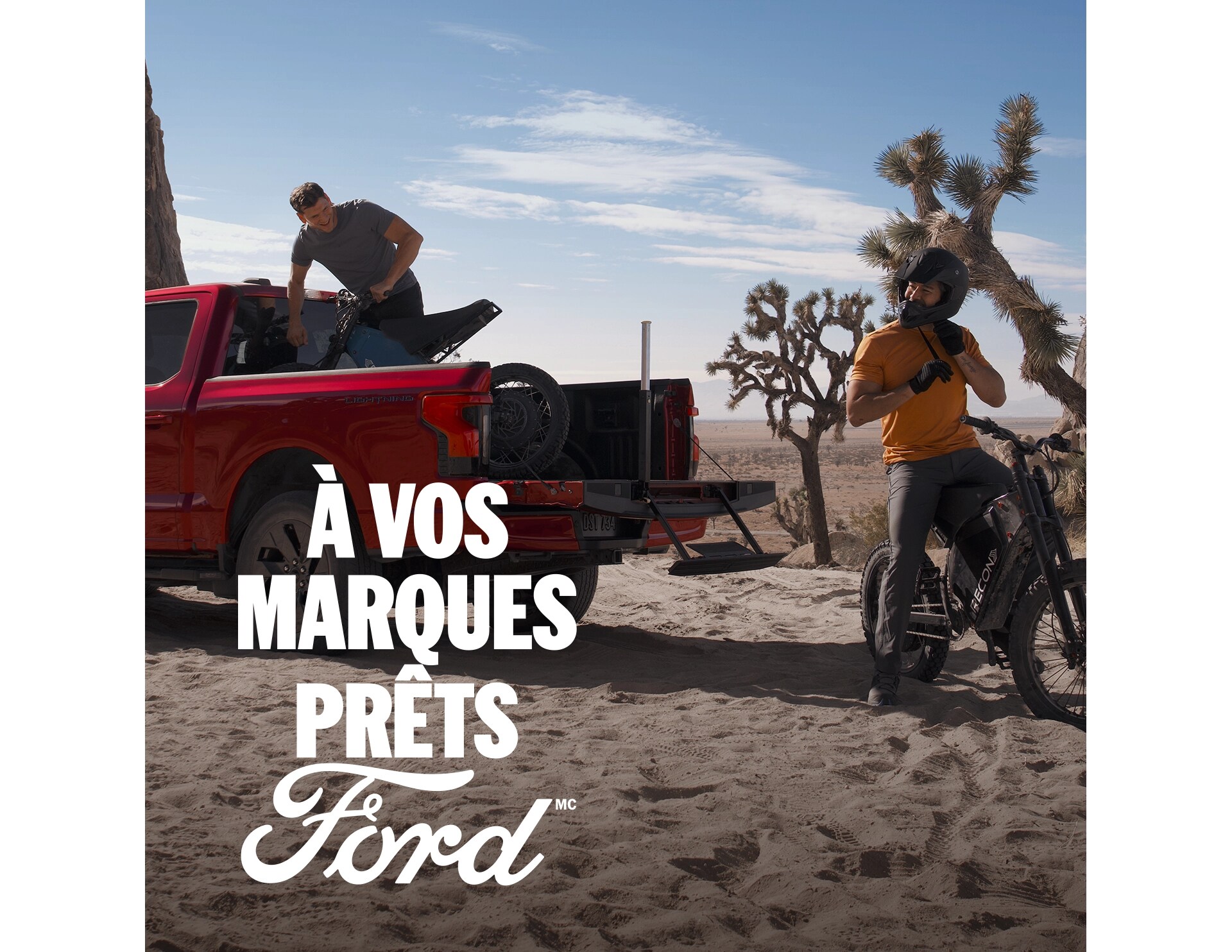 Two people unloading mountain bikes from the bed of a 2025 Ford F-150® Lightning®