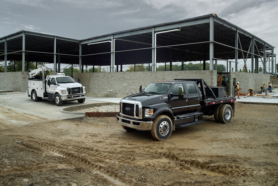 Ford F-750® 2026 à cabine double avec aménagement en blanc Oxford et Ford F-750® 2026 à cabine 6 places avec aménagement en noir agate sur un chantier