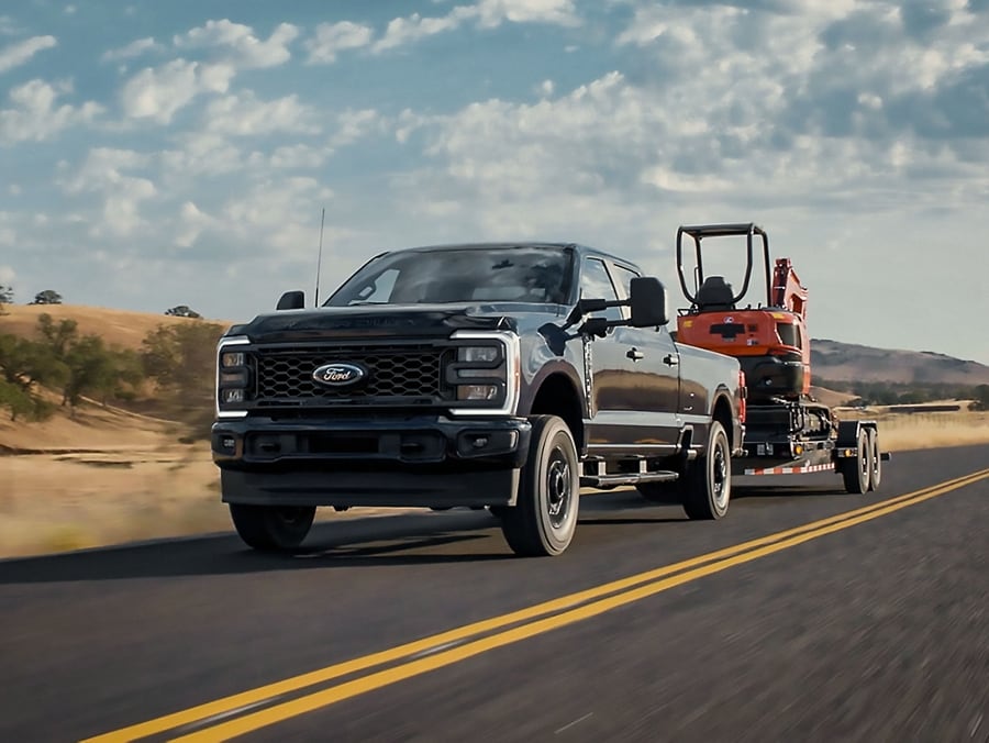 Modèle Ford Super Duty® STX® 2025 tirant un chariot élévateur sur une remorque