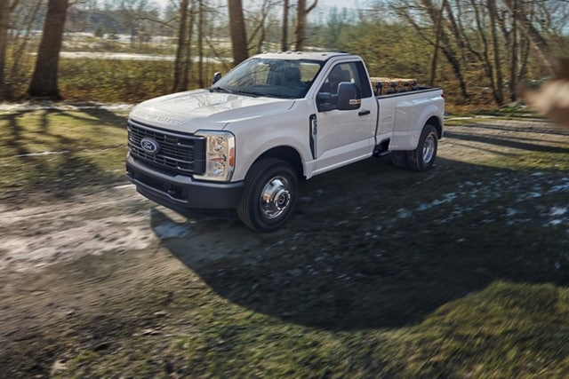 Ford Super Duty® F-350® XL à RAJ 2025 en blanc Oxford circulant sur un chemin de terre